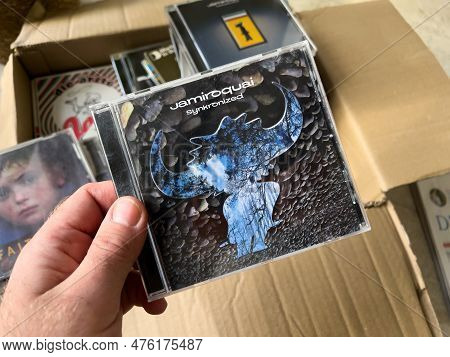 Paris, France - 1 Jan 13, 2023: A Man Holds A Cardboard Box Filled With Classic Media Recordings, Ab