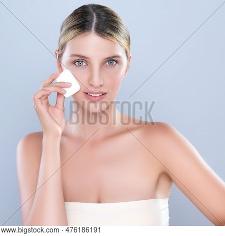 Alluring Beautiful Female Model Applying Powder Puff For Facial Makeup Concept. Portrait Of Flawless