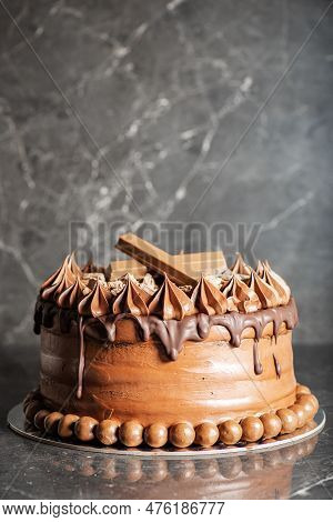 Deliciously Moist Chocolate Mud Cake With Whipped Ganache, Milk Chocolate Drip And Decoration.