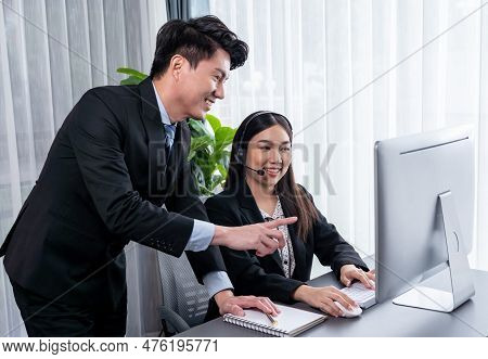 Manager Helps Female Call Center Operator With Customer Support. Asian Woman Call Center In Headset 