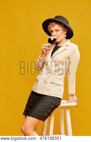 Portrait With Lady, Woman Wearing Black Hat Holding Dark Beer Glass And Drinking With Pleasure Over 