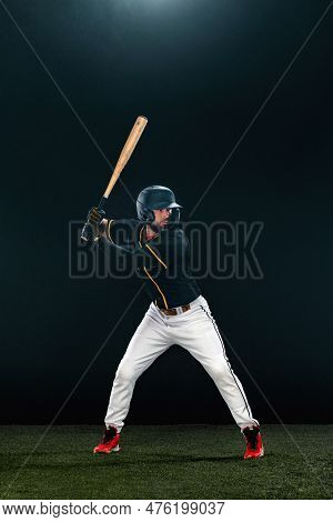 Baseball Player With Bat On Dark Background. Ballplayer Portrait.