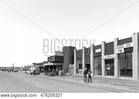 Groblershoop, South Africa - Feb 24, 2023: A Street Scene, With Businesses, People And Vehicles, In 