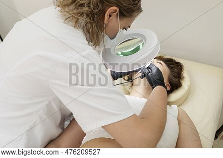 Dermatologist Removing Hair On Chin Of Patients Face With Electrolysis Procedure, Electric Epilation