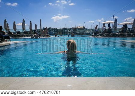 Valetta, Malta - April 17, 2023: Woman Relaxing In The Infinity Swimming Pool At Aqualuna Beach Club