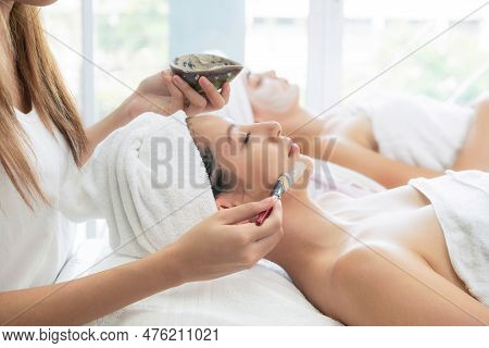 Beautiful Woman Having A Facial Cosmetic Scrub Treatment From Professional Dermatologist At Wellness