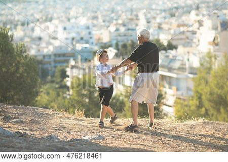 Old And Young. Family Generation And Relations Concept. Retired Grandfather And Grandson Playing Wit
