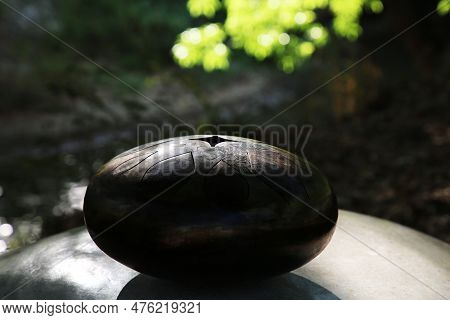 Steel Tongue Drum On Stone Outdoors. Percussion Musical Instrument