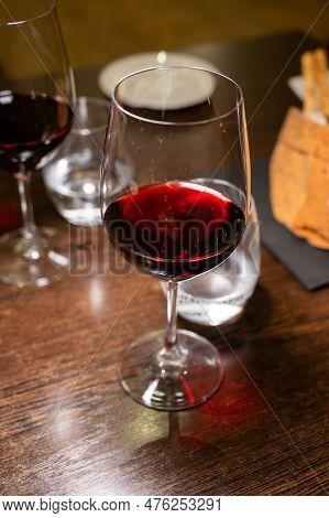 Dinner With Glass Of Dry Red Wine In Italian Osteria Restaurant