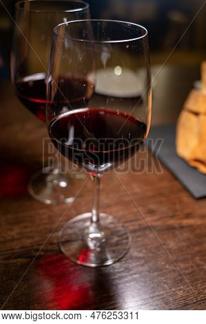 Dinner With Glass Of Dry Red Wine In Italian Osteria Restaurant