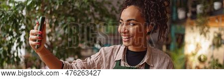 Smiling Woman Florist Taking Selfie With Her Plants For Publishing In Social Media In Florar Studio