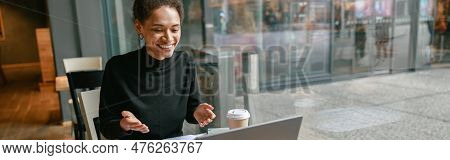 Woman Freelance Architect Talking With Client Via Video Call And Discuss Project Sitting In Cafe