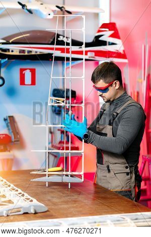 Professional Male Engineer Or Technician Working On Drone Details In Lab. Aircraft Capable Of Gps Su