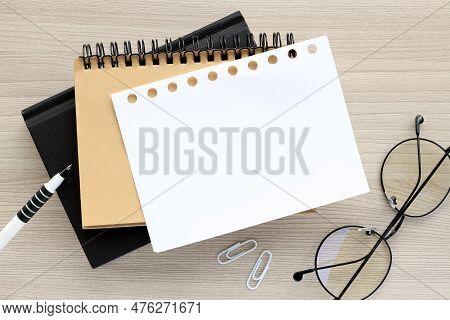 Office Atable With Blank Notebook. Business Background - On A Wooden Table Notebook With Pen, Glasse