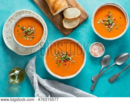 Gaspacho Soup On Blue Tabletop. Three Bowls Of Traditional Spanish Cold Soup Puree Gaspacho Or Gazpa