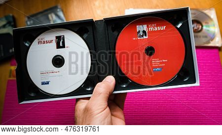 Paris, France - May 11, 2023: A Close-up Of A Male Musician Hand Holding A Sacd Super Audio Cd Disk 