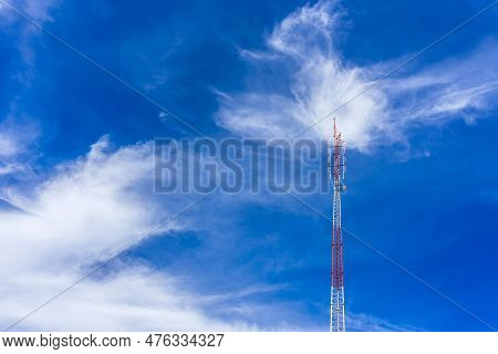 Telecommunication Radio Wave Signal Tower Red And White With Cloudy. Steel Truss Of Transmission Sig