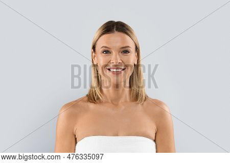 Pretty Adult Blonde Caucasian Woman Wrapped In Bathtowel