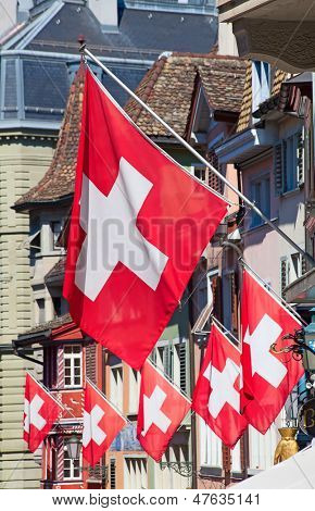 Gamle gade Augustinergasse i Zürich dekoreret med schweiziske flag