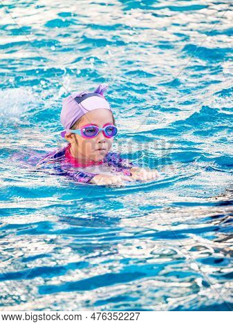 Asian Child Or Kid Girl Wearing Swimming Suit To Learning On Swimming Pool , Learn And Training Swim
