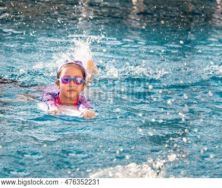 Asian Child Or Kid Girl Wearing Swimming Suit To Learning On Swimming Pool , Learn And Training Swim