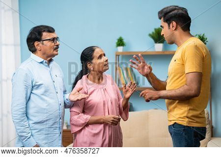 Angry Indian Adult Son Arguing With Elderly Senior Parents At Home - Concept Of Irresponsibility, Fa