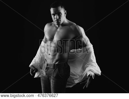 Man Take Off Shirt. Mens Fashion Concept. Muscular Shirtless Manked Man Model Showing Six Pack Abs. 