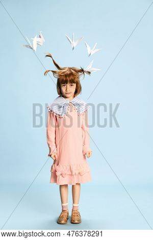 Full-length Portrait Of Cute, Lovely Little Girl, Child In Pink Dress Posing With Paper Birds Above 