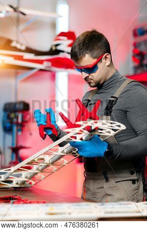 Expert Male Engineer Or Technician Working On Drone Details In Lab. Aircraft Capable Of Gps Surveill