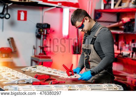 Expert Male Engineer Or Technician Working On Drone Details In Lab. Aircraft Capable Of Gps Surveill