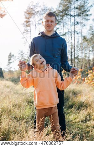 Happy Fathers Day. Dad And Son On A Walk In The Forest In Sunny Weather. Family Leisure. The Father 