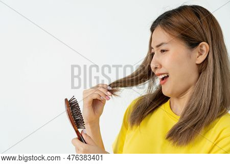 Asian Woman Very Sad And Upset Looking At Damaged Hair, Hair Loss, Hair Thinning Problem, Vitamin De
