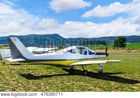 Single Engine Ultralight Airplane Waiting To Take Off At The Airfield With Blue Sky And Field Backgr