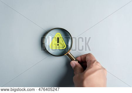 System Warning Caution Sign Inside Magnifier For Notification Error And Maintenance. Cyber Attack On