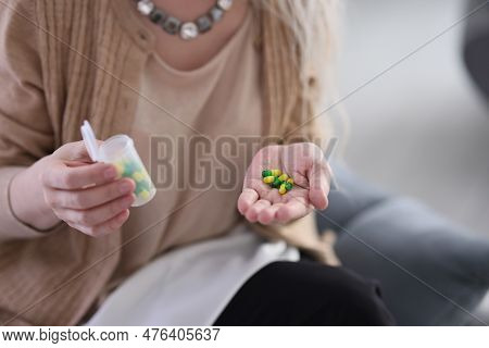 Woman Holds On Palm Pills With Vitamins To Maintain Body Health. Grey Haired Woman Holds Plastic Con