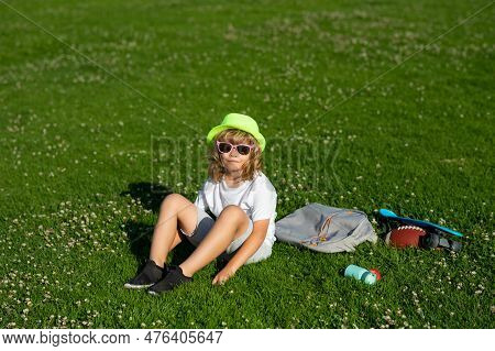Kids Relaxation. Child Go For A Walk In The Park. Summer Holiday Activitie. Kid Boy Are Relaxing Out