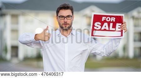 Handsome Real Estate Agent Holding Banner House For Sale. House With Land And Insurance. Business Ma