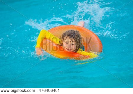 Swimming, Summer Vacation. Child Swim In Pool On Inflatable Ring. Kid With Inflatable Ring In Swimmi
