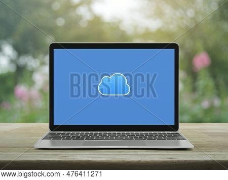 Cloud Computing Icon On Modern Laptop Computer Monitor Screen On Wooden Table Over Blur Pink Flower 