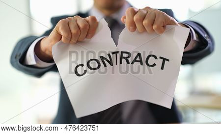 Businessman In Suit Tearing Up Job Contract In Office Closeup. Termination Of Contracts And Transact