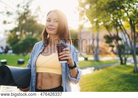 Attractive Caucasian Woman Holding Cup In The Garden, Drinking Hot Tea And Smile, Relaxation In Publ