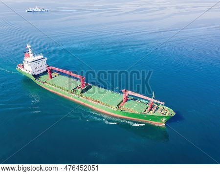 Cargo Bulker Ship, Bulk Carrier With Deck Cranes Sailing In Sunny Day, Side Aerial View