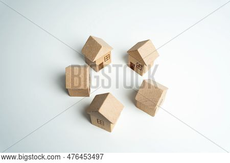 Wooden Toy Houses Stand In A Circle. Community Of Homeowners. Build, Buy Or Sell Real Estate. Constr
