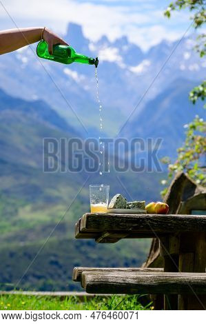 Pouring From High Height Of Natural Asturian Cider Made From fermented Apples, Asturian Cabrales Cow