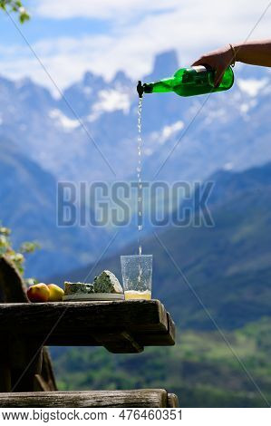 Pouring From High Height Of Natural Asturian Cider Made From fermented Apples, Asturian Cabrales Cow