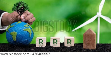 Businessman Holding Paper Globe With Wind Turbine And Reduce Reuse Recycle Symbol Cube For Environme