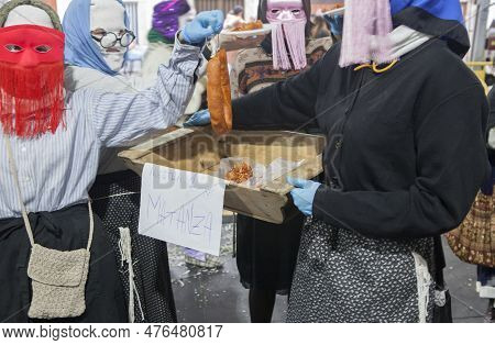 Montanchez, Spain - February 18, 2023: The Jurramacho Carnival Of Montanchez. Participants Handing O