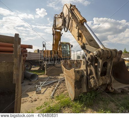 A Very Powerful Wheeled Excavator At A Construction Site After Work. A Strong Machine With A Large B