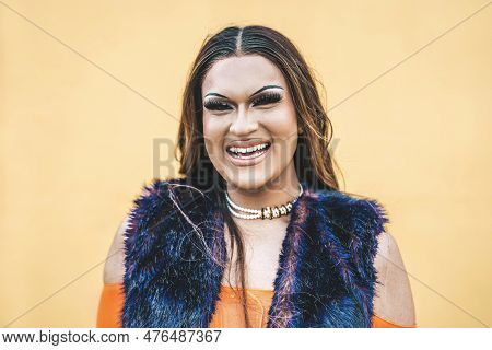 Happy Drag Queen Smiling At Camera On A Yellow Background