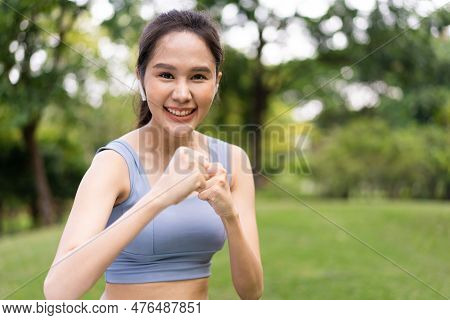 Fitness Asian Girl In Tight Sportswear Doing Exercises And Punching Boxing Footwork Cardio Exercise 